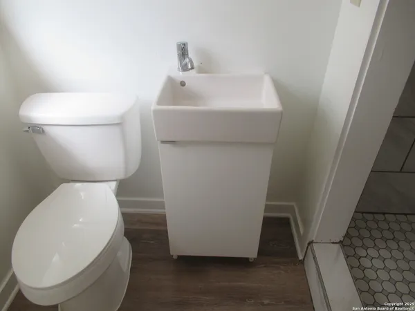 a white toilet sitting next to a sink