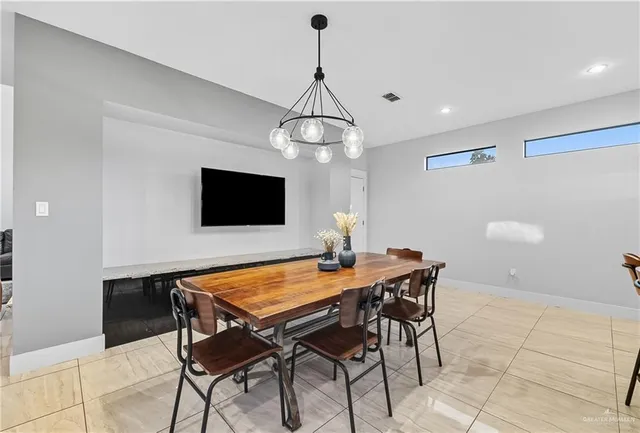 a dining room with a table and chairs