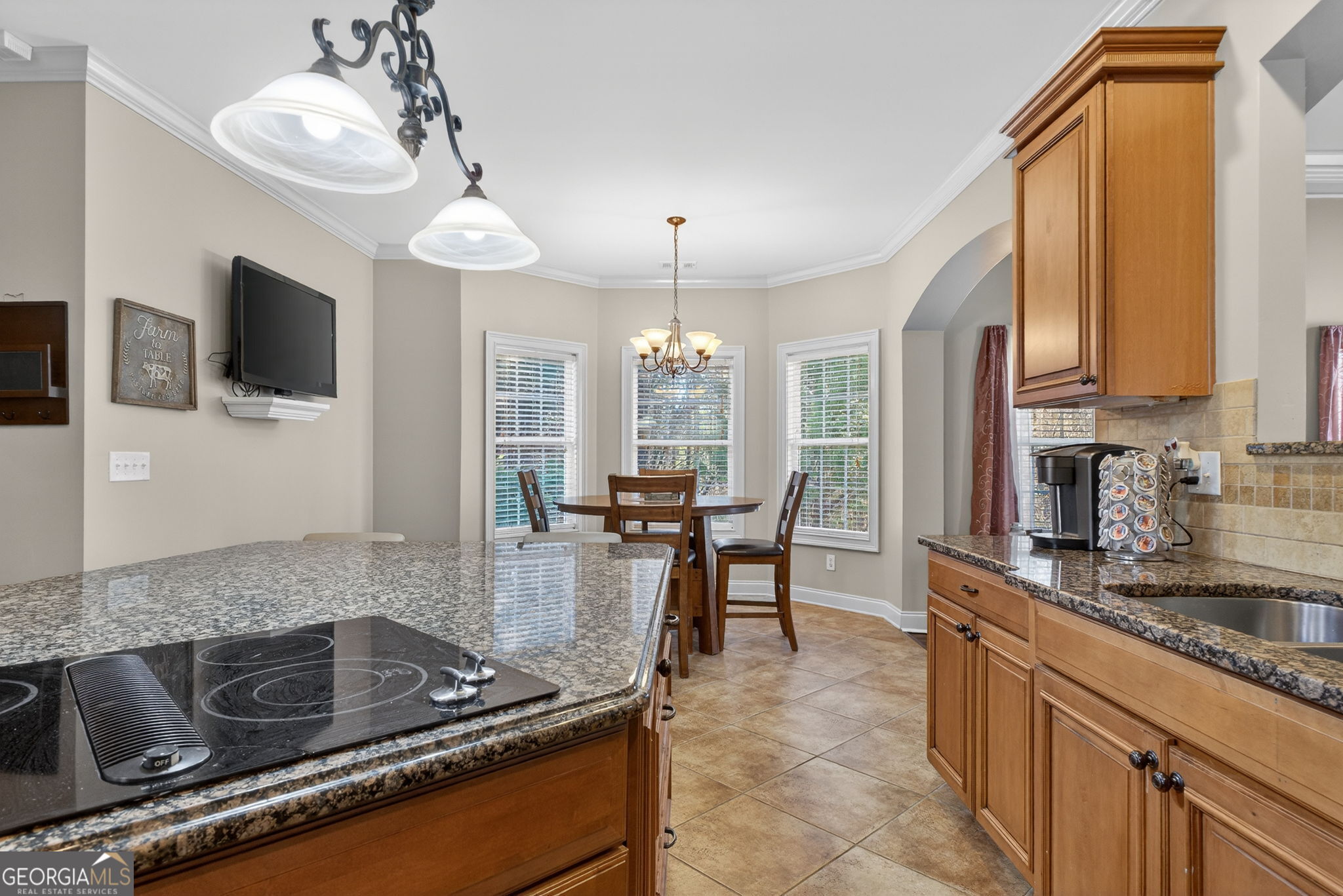 32 River Rapids Drive Forsyth, GA 31029 - Photo 11 of 32 a kitchen with kitchen island granite countertop a sink cabinets and window