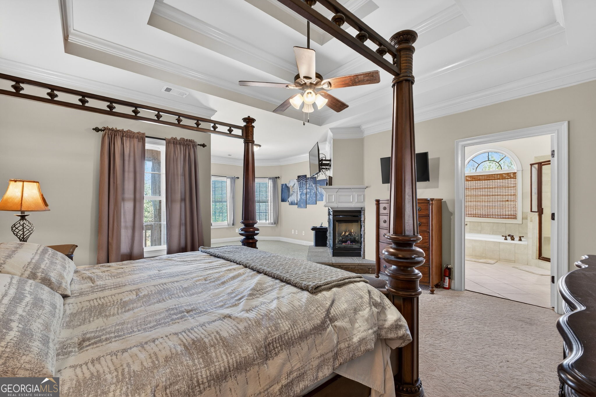 32 River Rapids Drive Forsyth, GA 31029 - Photo 16 of 32 a bedroom with a bed dresser and a flat screen tv