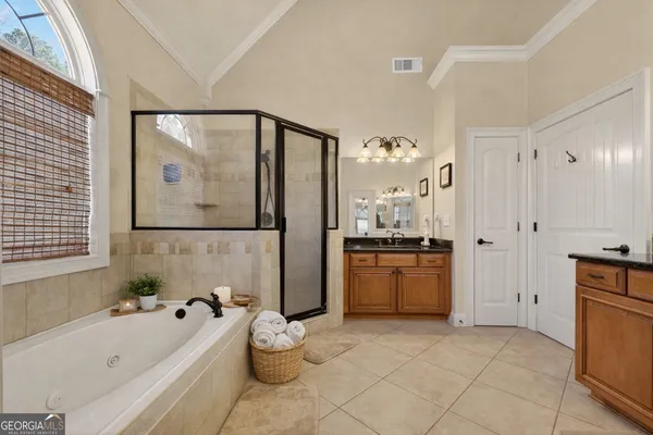 a bathroom with a tub sink and mirror
