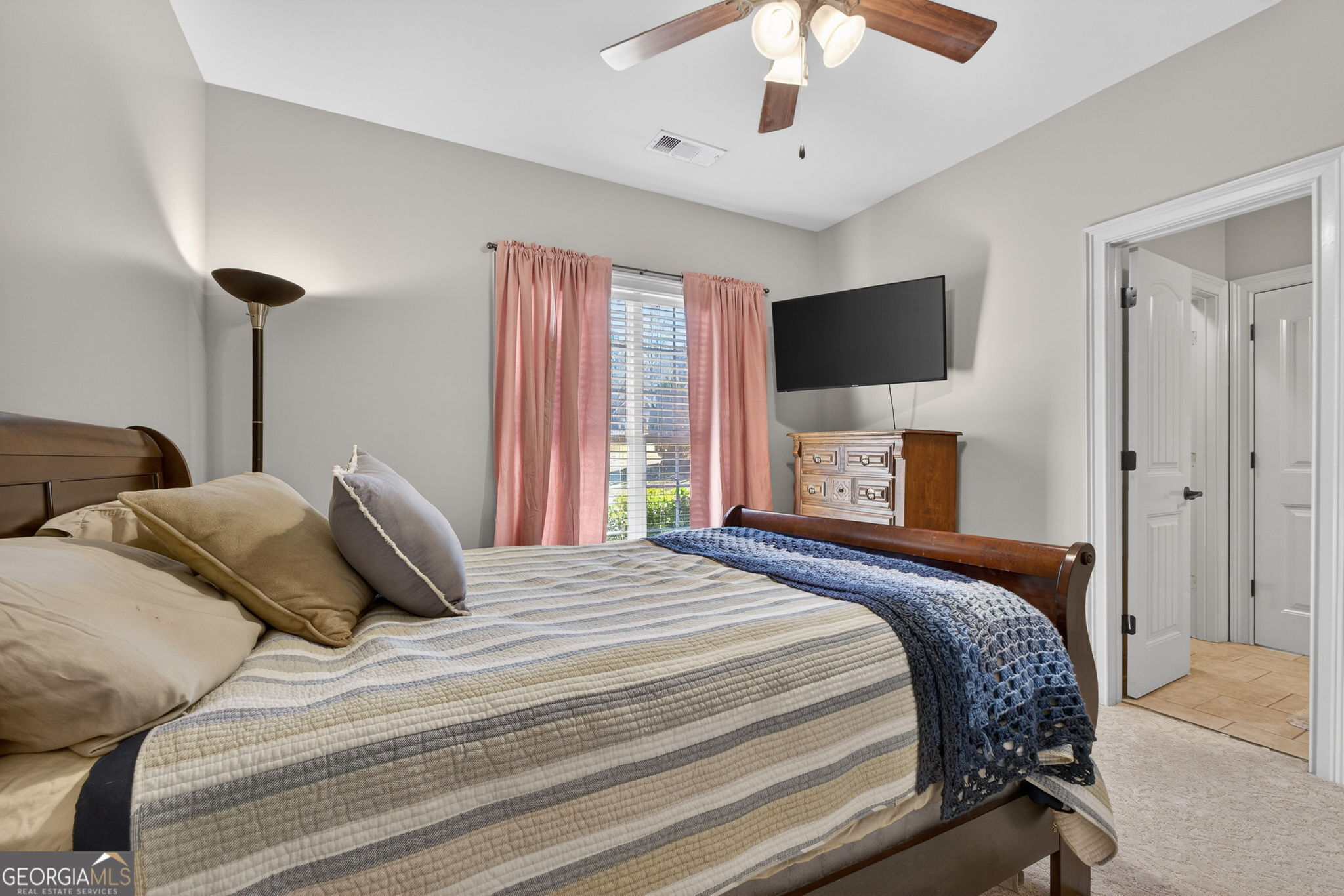 32 River Rapids Drive Forsyth, GA 31029 - Photo 21 of 32 a bedroom with a large bed and a tv