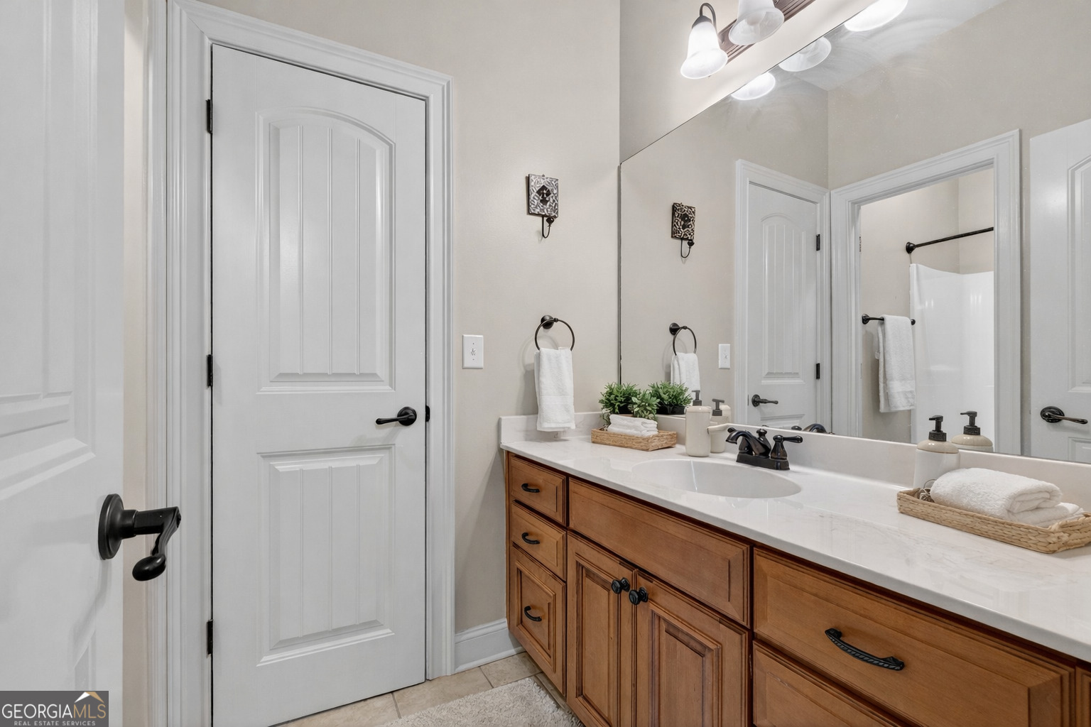 32 River Rapids Drive Forsyth, GA 31029 - Photo 22 of 32 a bathroom with double vanity sinks and a mirror