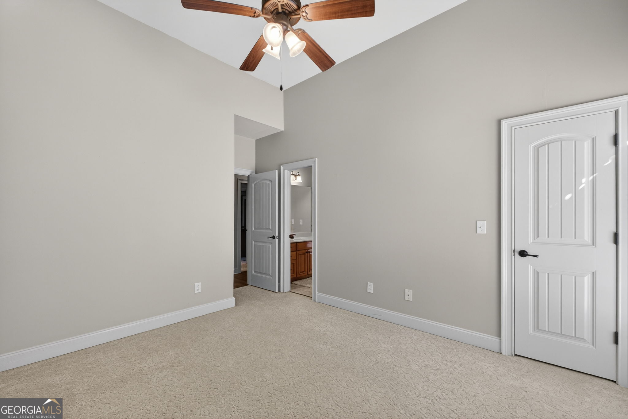 32 River Rapids Drive Forsyth, GA 31029 - Photo 23 of 32 an empty room with closet and a chandelier fan
