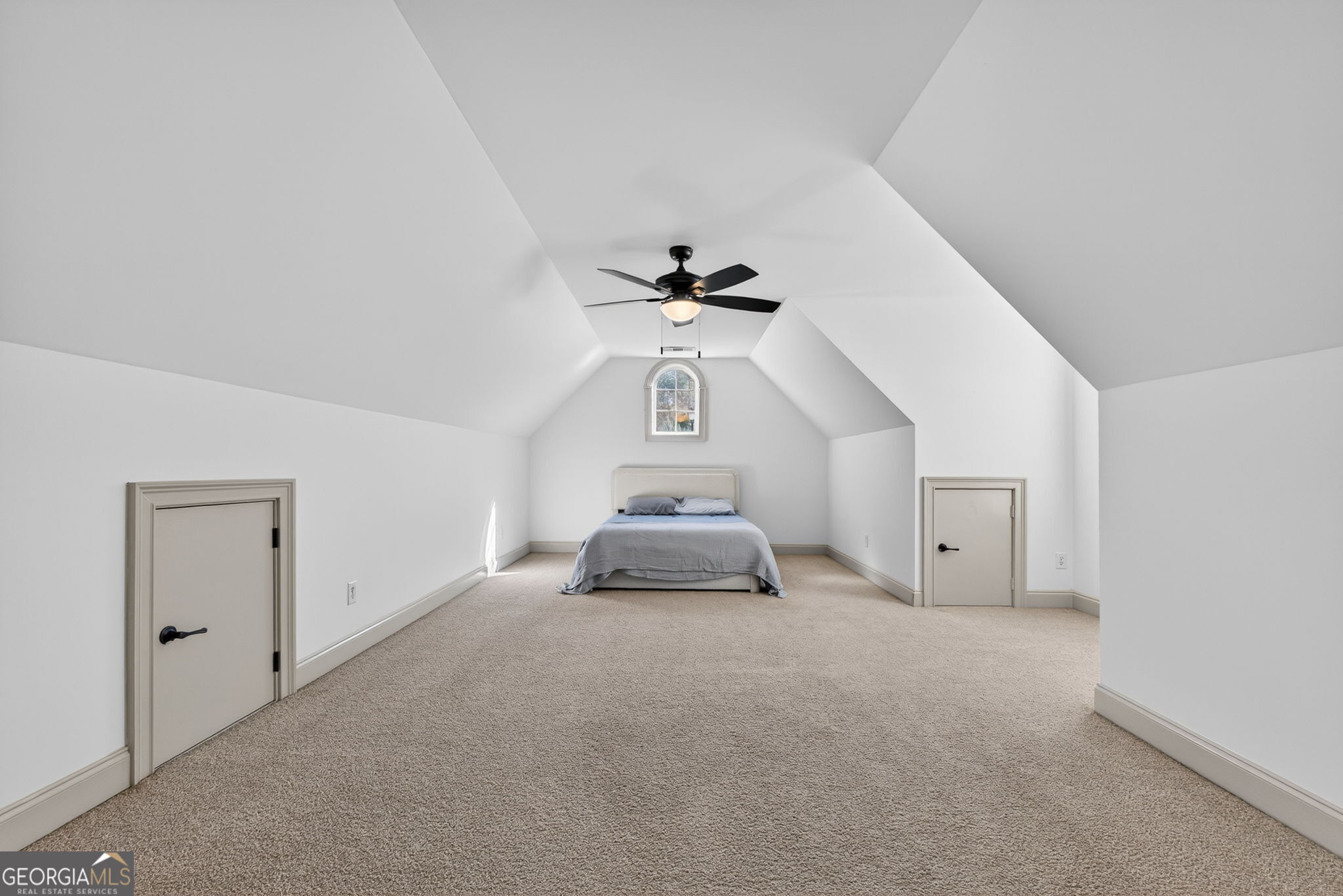 32 River Rapids Drive Forsyth, GA 31029 - Photo 24 of 32 an empty room with a chandelier fan and wooden floor