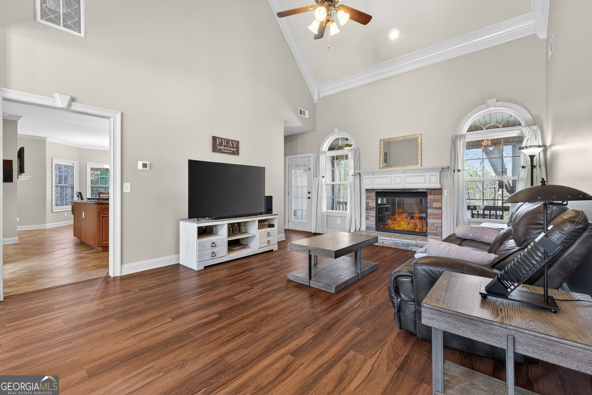 32 River Rapids Drive Forsyth, GA 31029 - Photo 5 of 32 a living room with furniture a flat screen tv and a fireplace