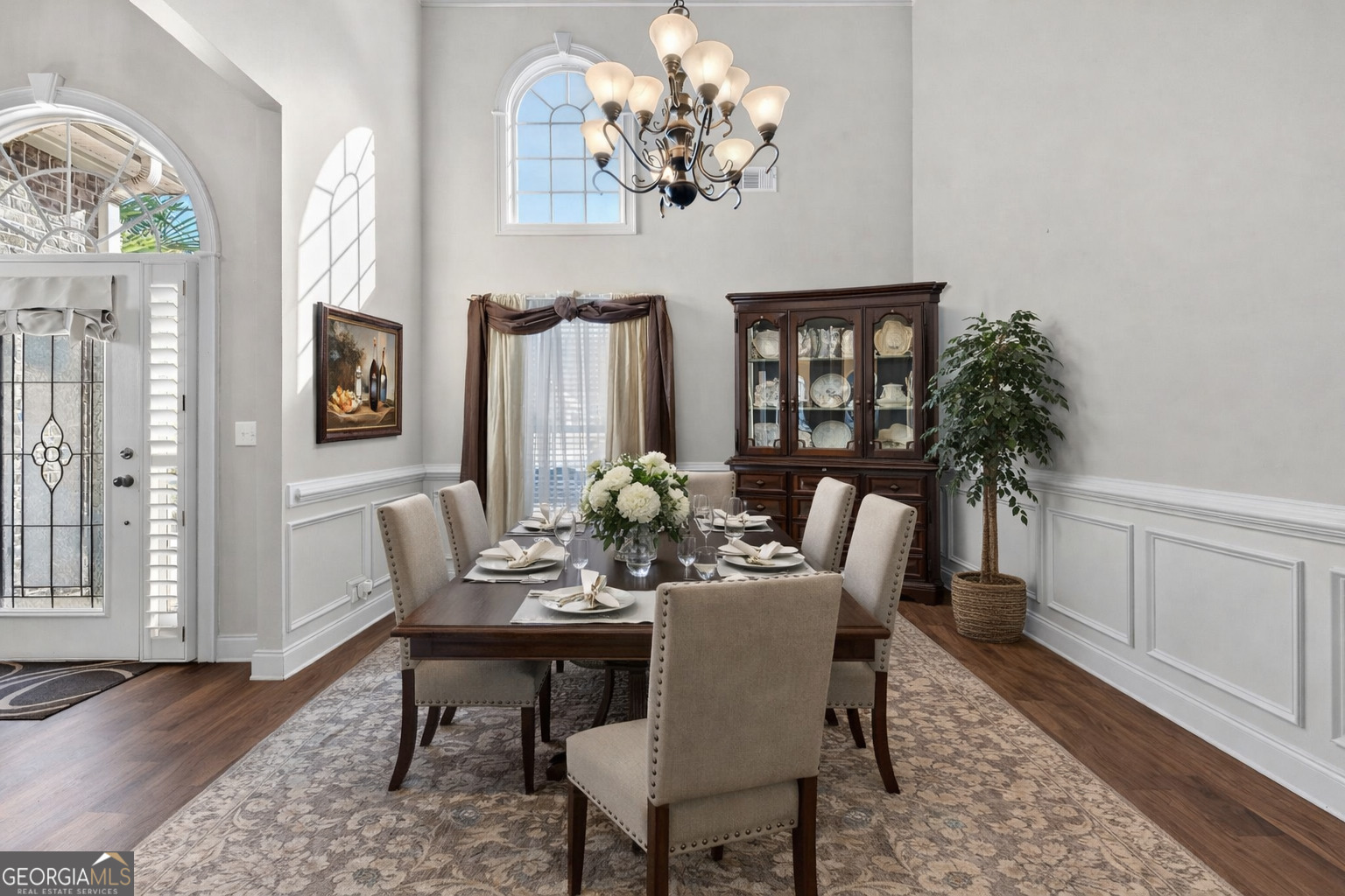 32 River Rapids Drive Forsyth, GA 31029 - Photo 7 of 32 a view of a dining room with furniture a chandelier and wooden floor