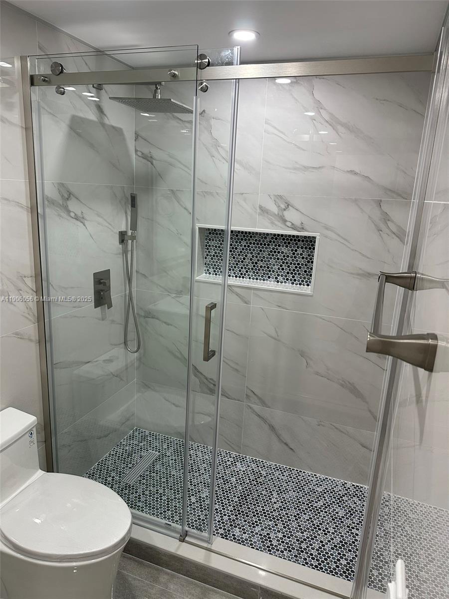 5280 Northwest 7th Street, Unit 306 Miami, FL 33126 - Photo 12 of 23 a bathroom with a toilet and a shower