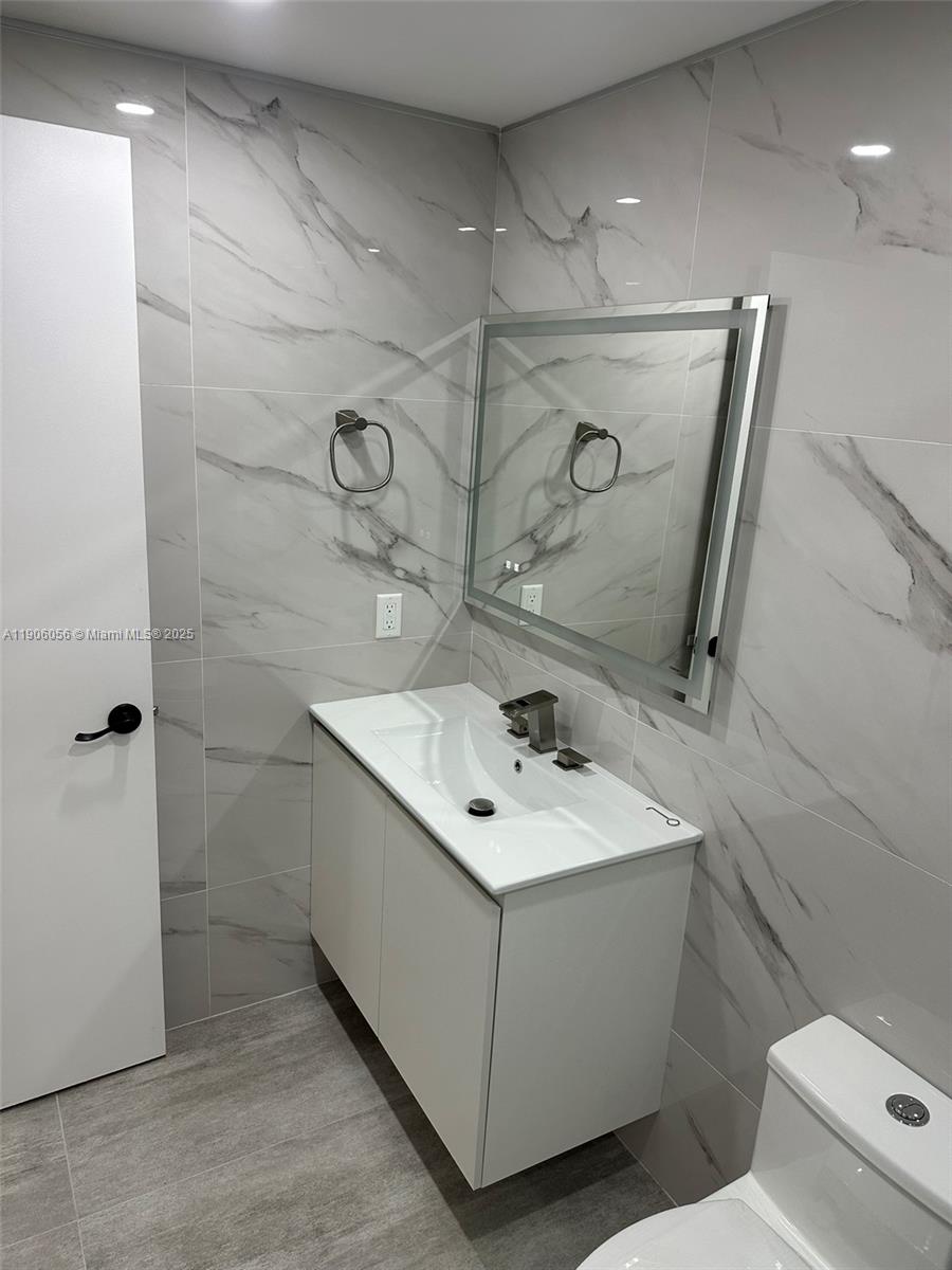 5280 Northwest 7th Street, Unit 306 Miami, FL 33126 - Photo 13 of 23 a bathroom with a sink toilet and shower