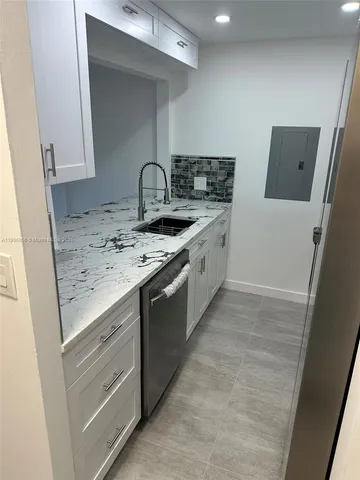 a kitchen with a sink and cabinets
