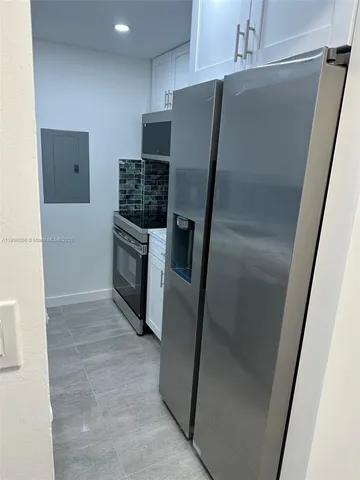 a kitchen with stainless steel appliances a refrigerator and a sink