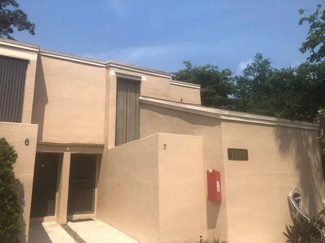 a view of a patio with table and chairs with wooden floor and fence