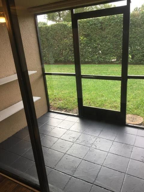 1189 Northwest 13th Street, Unit 7 Boca Raton, FL 33486 - Photo 11 of 15 a view of a garden from a window