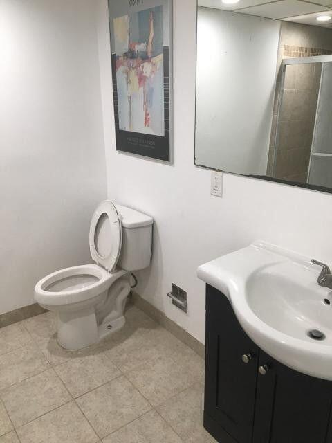 1189 Northwest 13th Street, Unit 7 Boca Raton, FL 33486 - Photo 5 of 15 a bathroom with a toilet sink and mirror