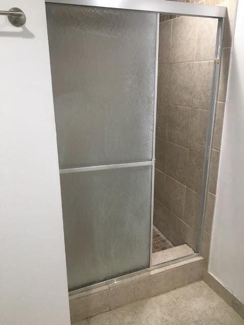 1189 Northwest 13th Street, Unit 7 Boca Raton, FL 33486 - Photo 6 of 15 a bathroom with a glass shower door