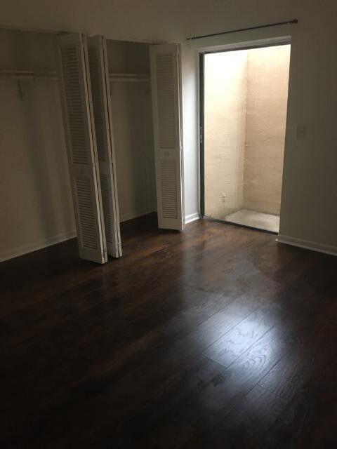 1189 Northwest 13th Street, Unit 7 Boca Raton, FL 33486 - Photo 7 of 15 a view of a room with wooden floor and a window