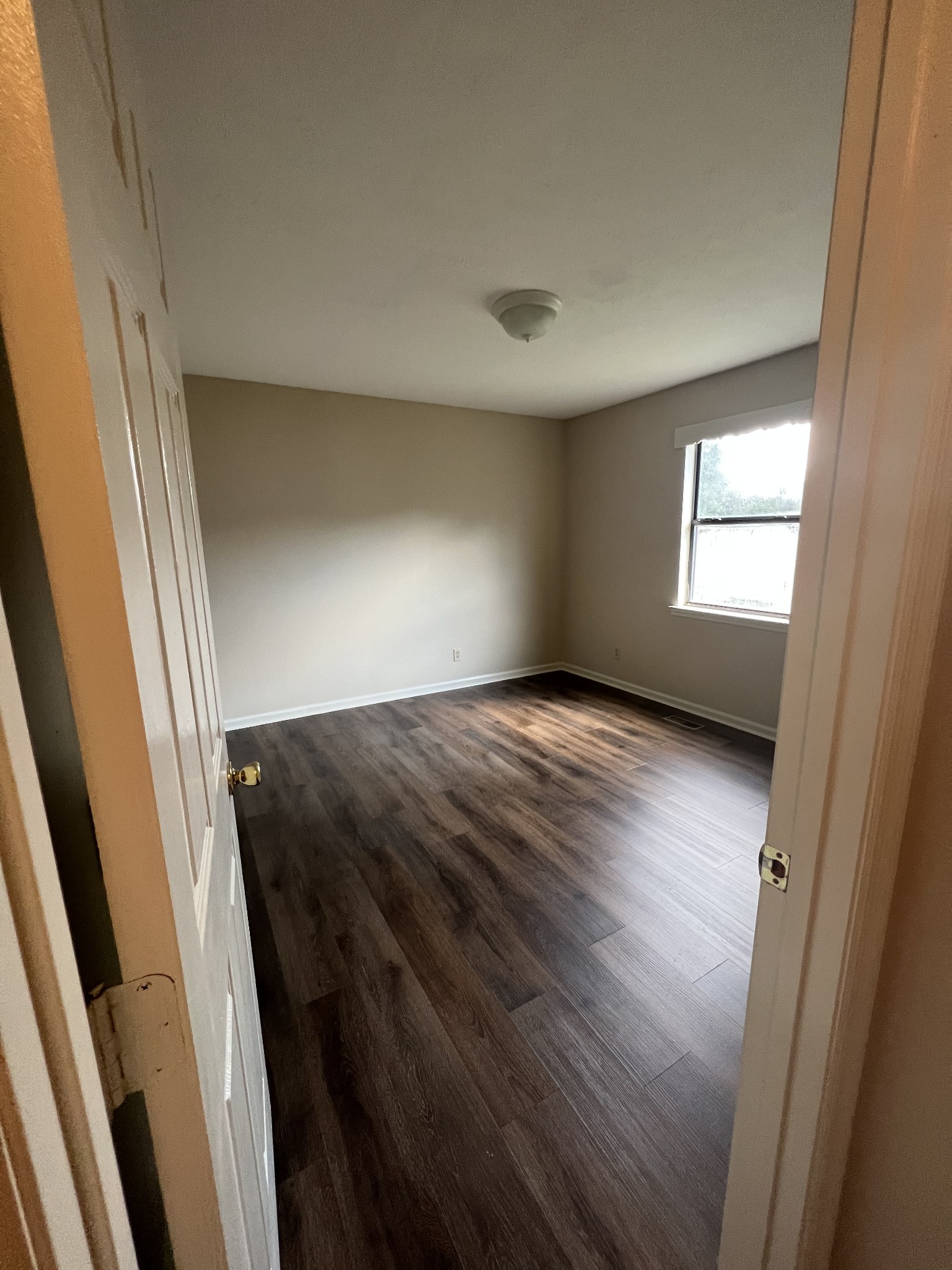 5012 Jacksboro Road Morrison, TN 37357 - Photo 8 of 13 an empty room with wooden floor and windows