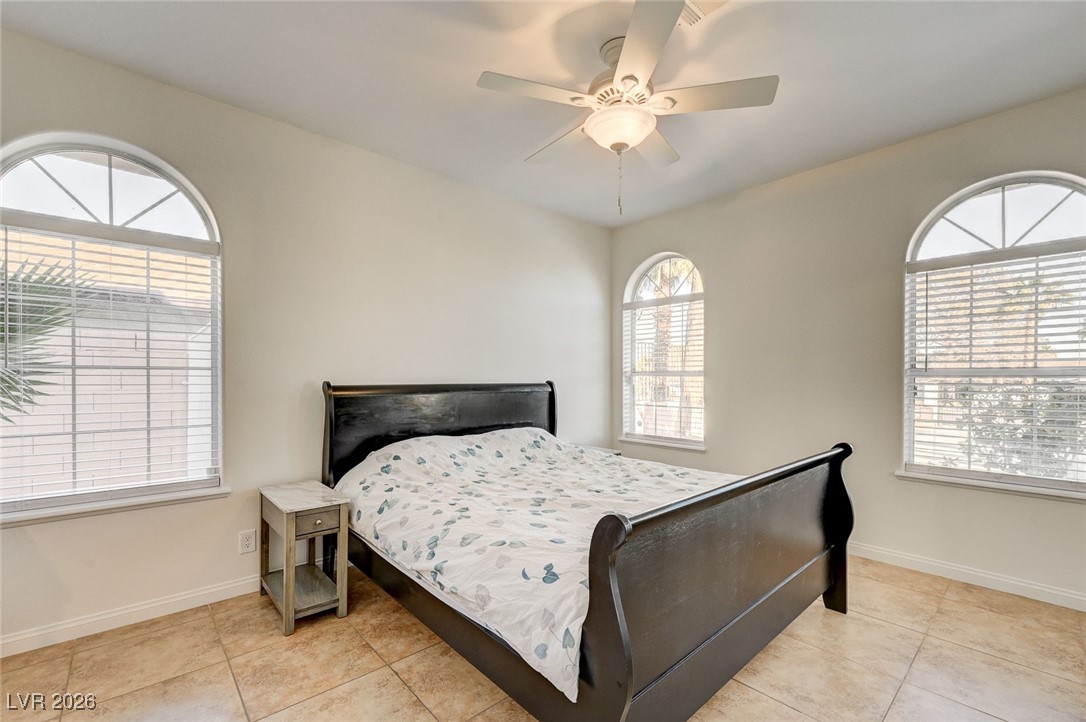 2955 El Camino Road Las Vegas, NV 89146 - Photo 44 of 99 Bedroom featuring ceiling fan, multiple windows, and light tile patterned floors