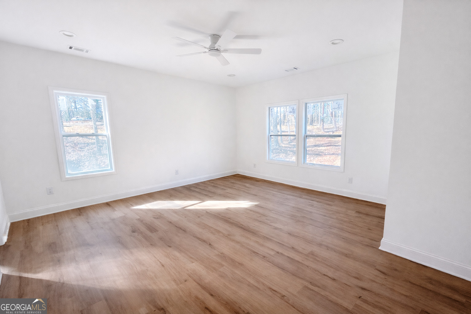 204 Custer Circle Griffin, GA 30223 - Photo 11 of 17 wooden floor in an empty room with a window