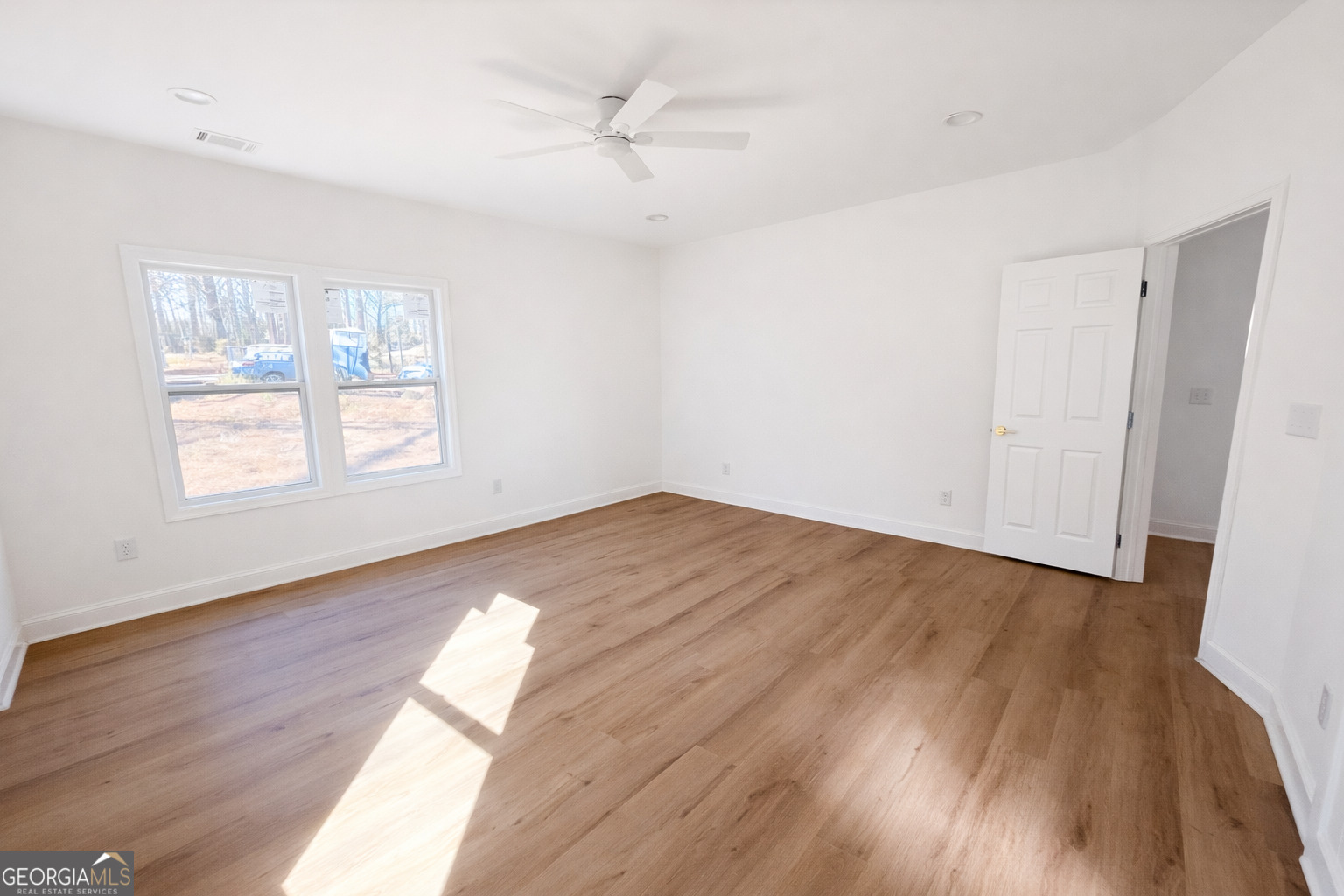 204 Custer Circle Griffin, GA 30223 - Photo 12 of 17 an empty room with wooden floor and windows