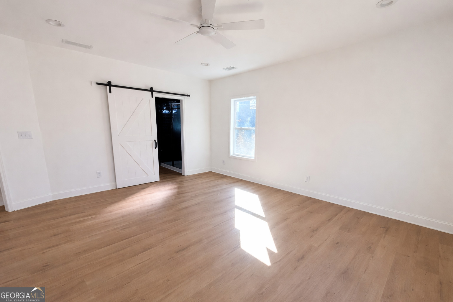 204 Custer Circle Griffin, GA 30223 - Photo 13 of 17 an empty room with wooden floor and windows