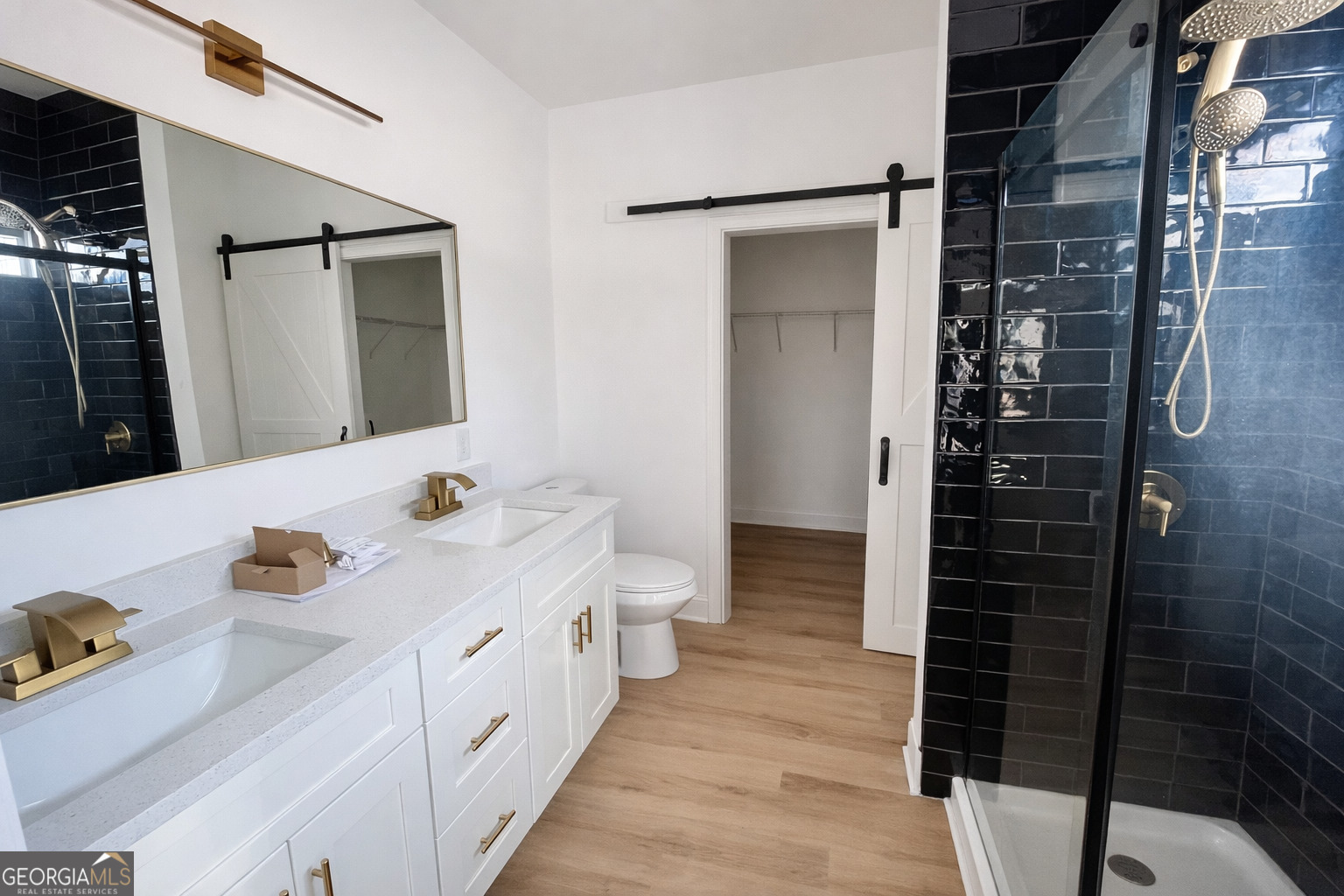 204 Custer Circle Griffin, GA 30223 - Photo 14 of 17 a bathroom with a double vanity sink a toilet and shower