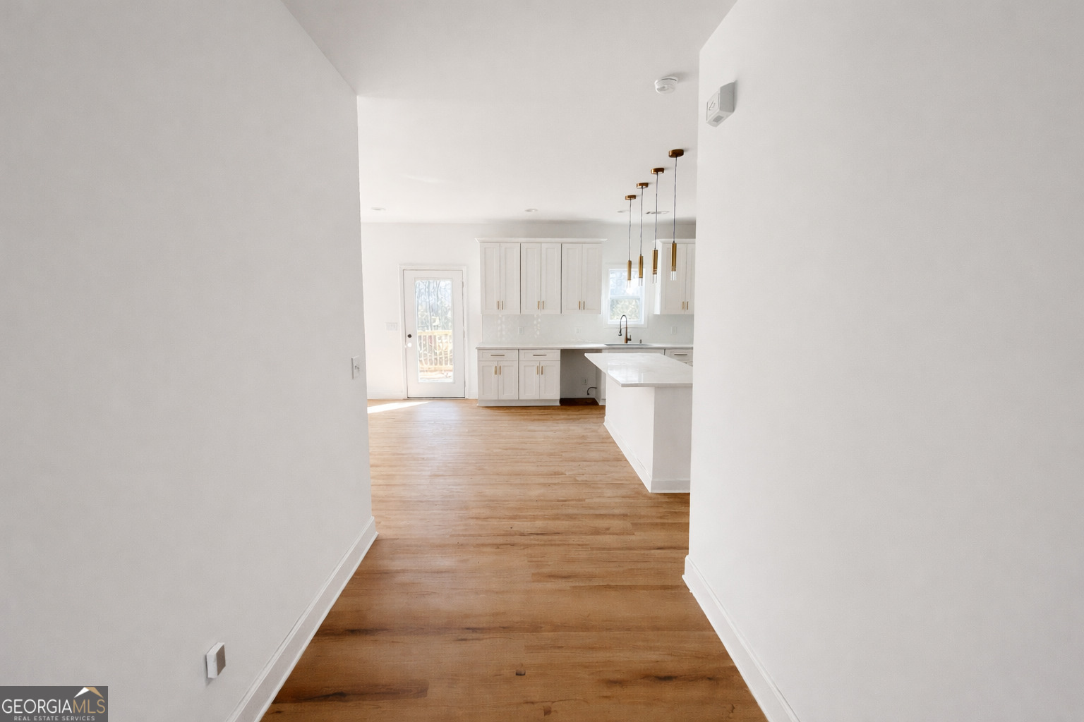 204 Custer Circle Griffin, GA 30223 - Photo 2 of 17 a hallway with white cabinets and wooden floor