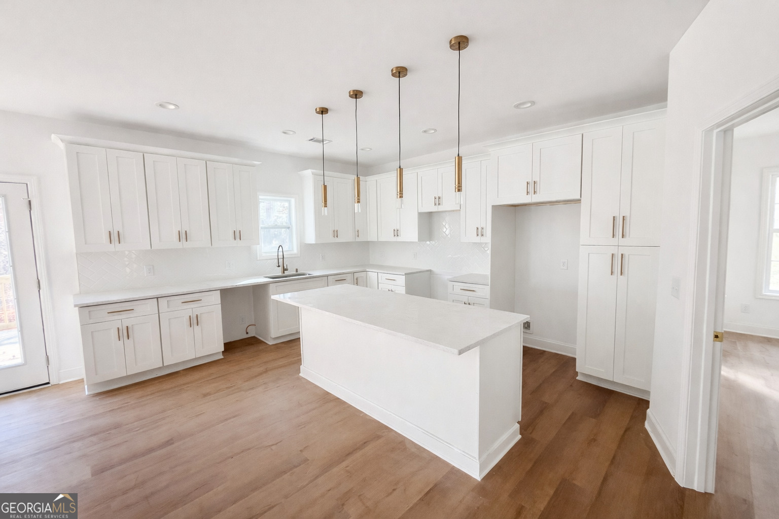 204 Custer Circle Griffin, GA 30223 - Photo 3 of 17 a kitchen with white cabinets and white appliances