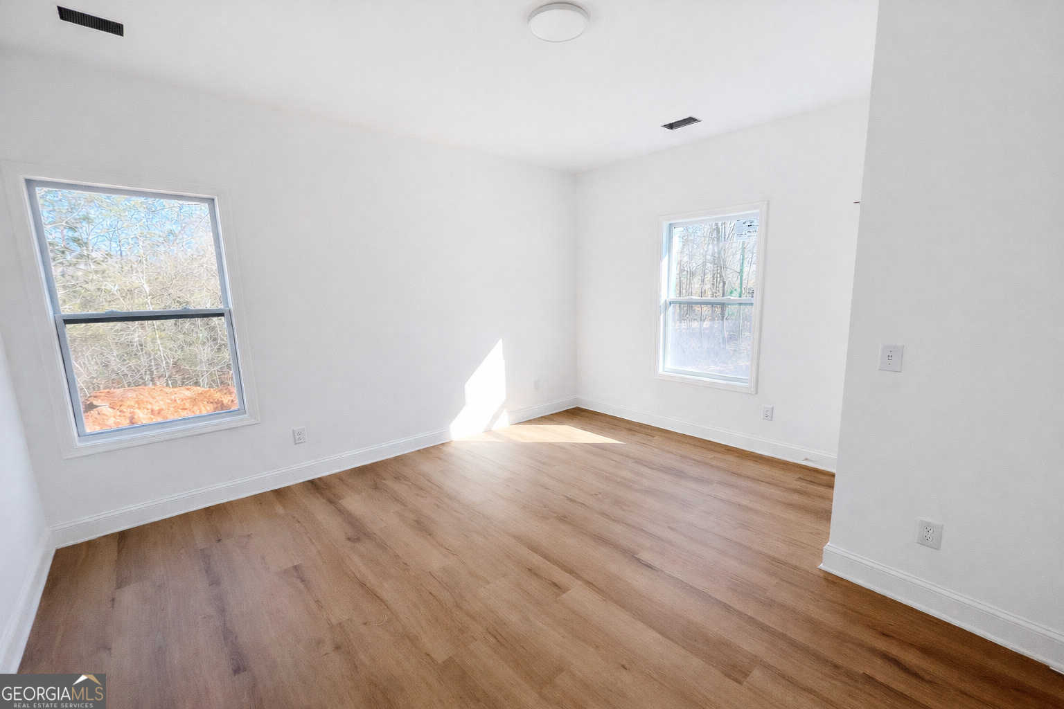 204 Custer Circle Griffin, GA 30223 - Photo 9 of 17 an empty room with wooden floor and windows