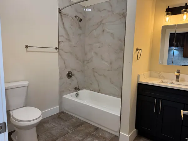 a bathroom with a sink toilet and shower