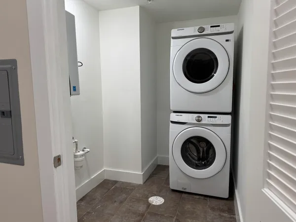 a utility room with sink dryer and washer