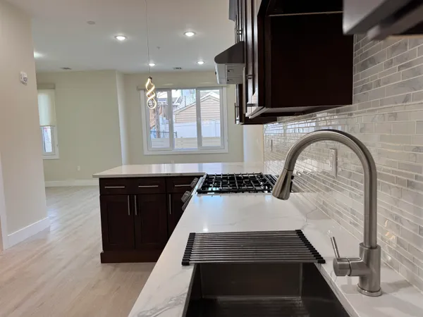 a view of a kitchen with a sink and cabinets