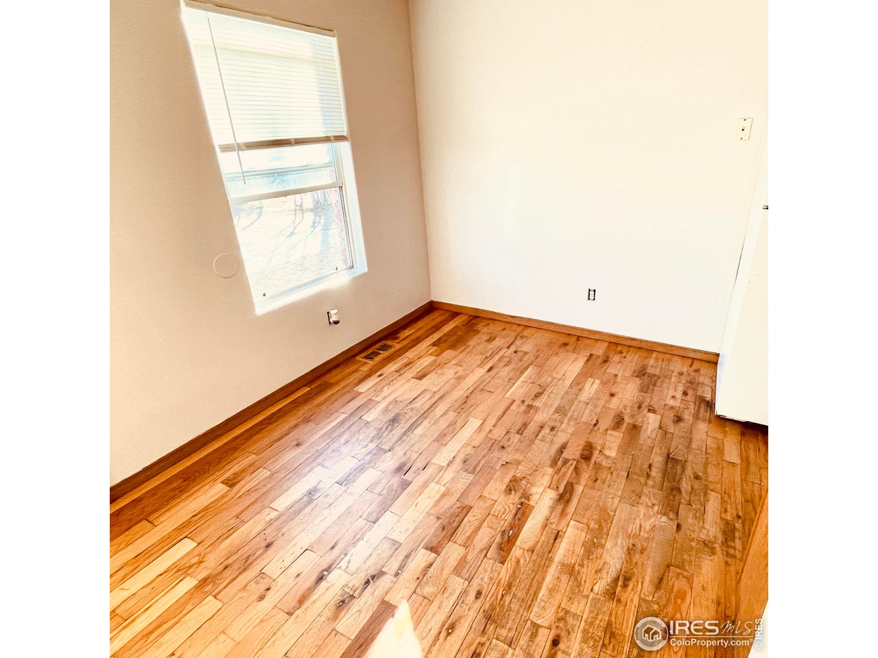 1317 Darrell Road Evans, CO 80620 - Photo 6 of 15 a view of empty room with wooden floor