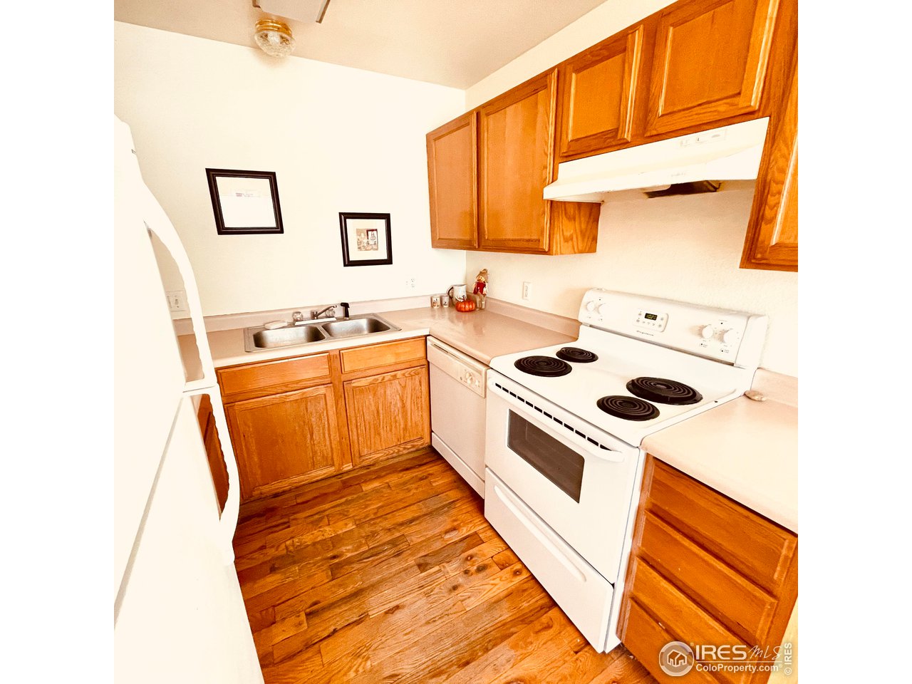 1317 Darrell Road Evans, CO 80620 - Photo 7 of 15 a kitchen with a sink a stove and white cabinets