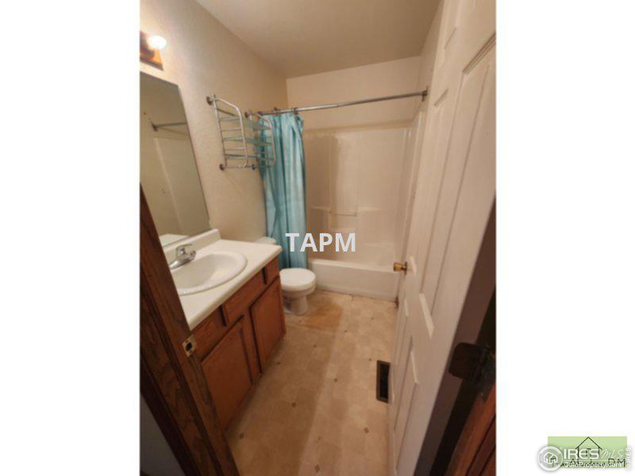 1317 Darrell Road Evans, CO 80620 - Photo 9 of 15 a bathroom with a sink a mirror and a shower