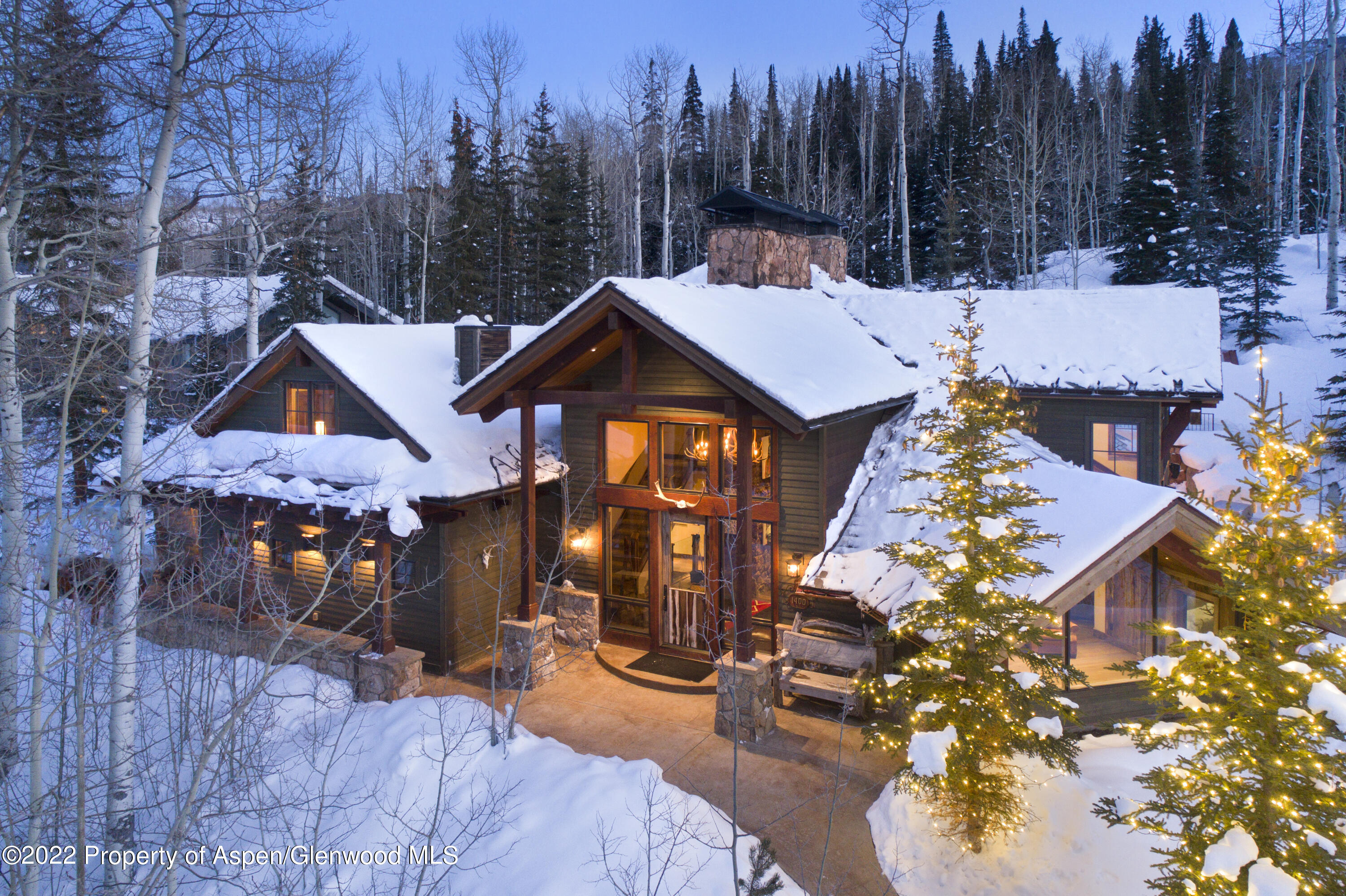 a view of a town with brick wall and large tree