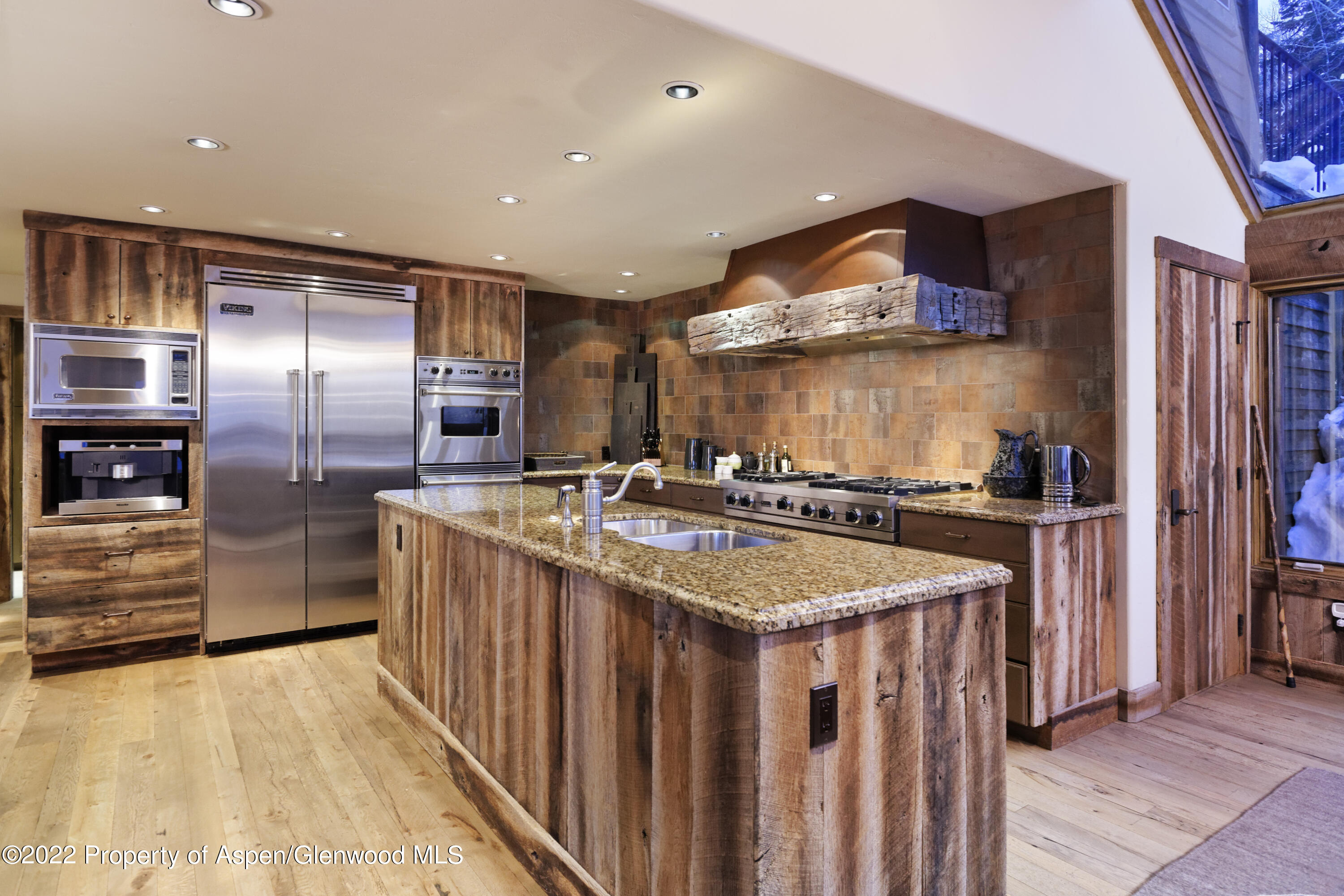 1400 Wood Road Snowmass Village, CO 81615 - Photo 11 of 36 a kitchen with stainless steel appliances granite countertop a sink and a refrigerator