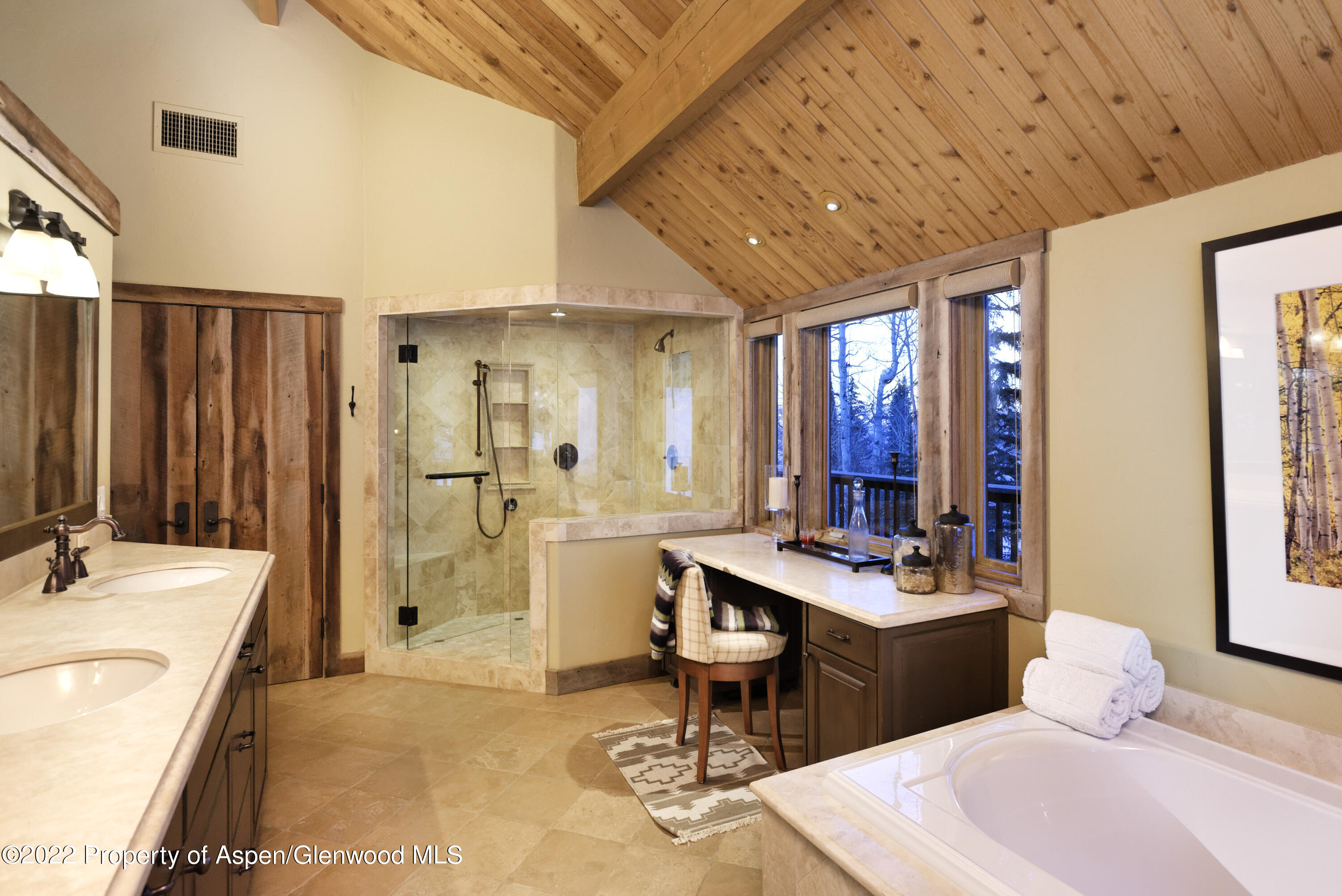 1400 Wood Road Snowmass Village, CO 81615 - Photo 15 of 36 a spacious bathroom with a double vanity sink a mirror and a bathtub