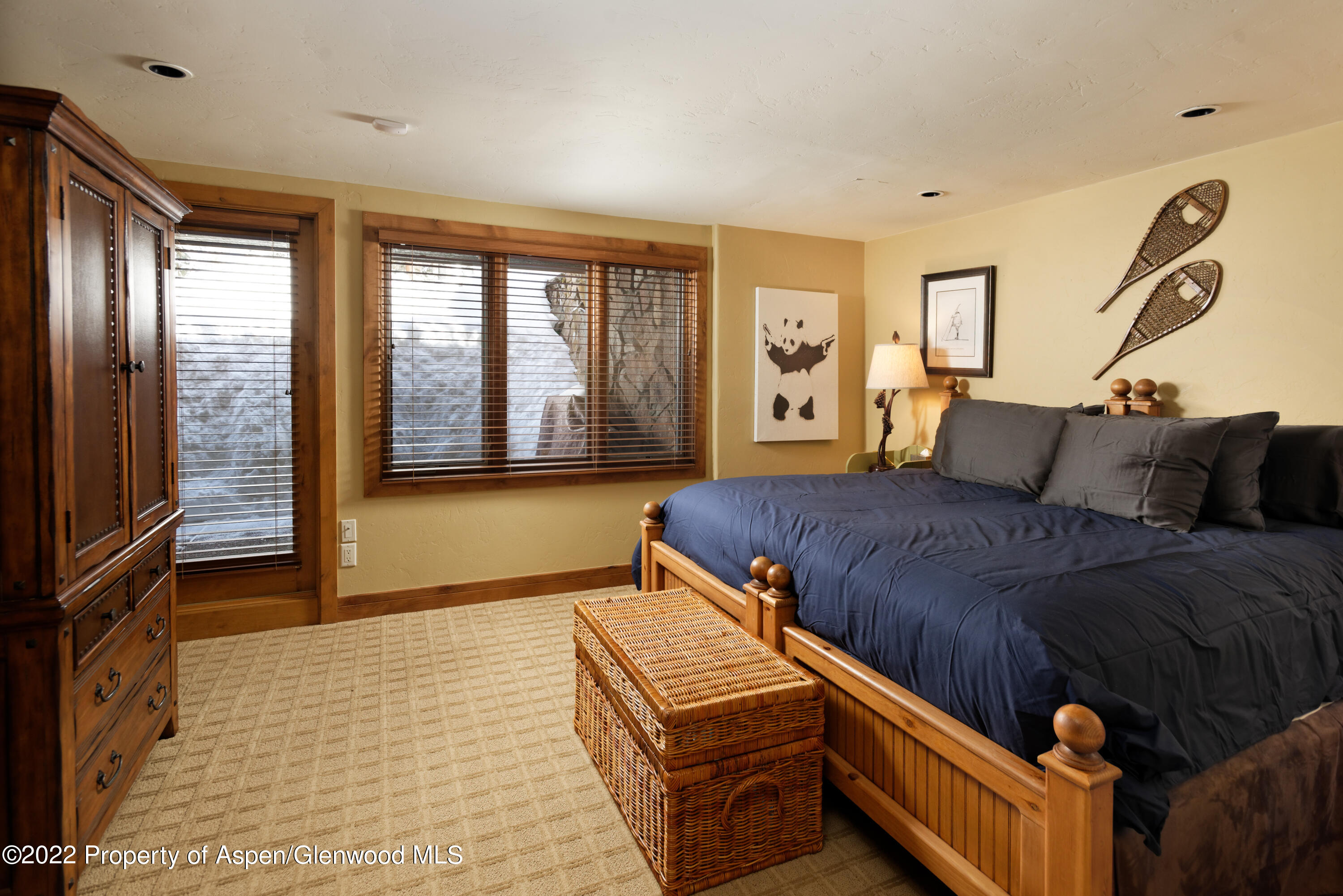 1400 Wood Road Snowmass Village, CO 81615 - Photo 19 of 36 a bedroom with a bed and wooden floor