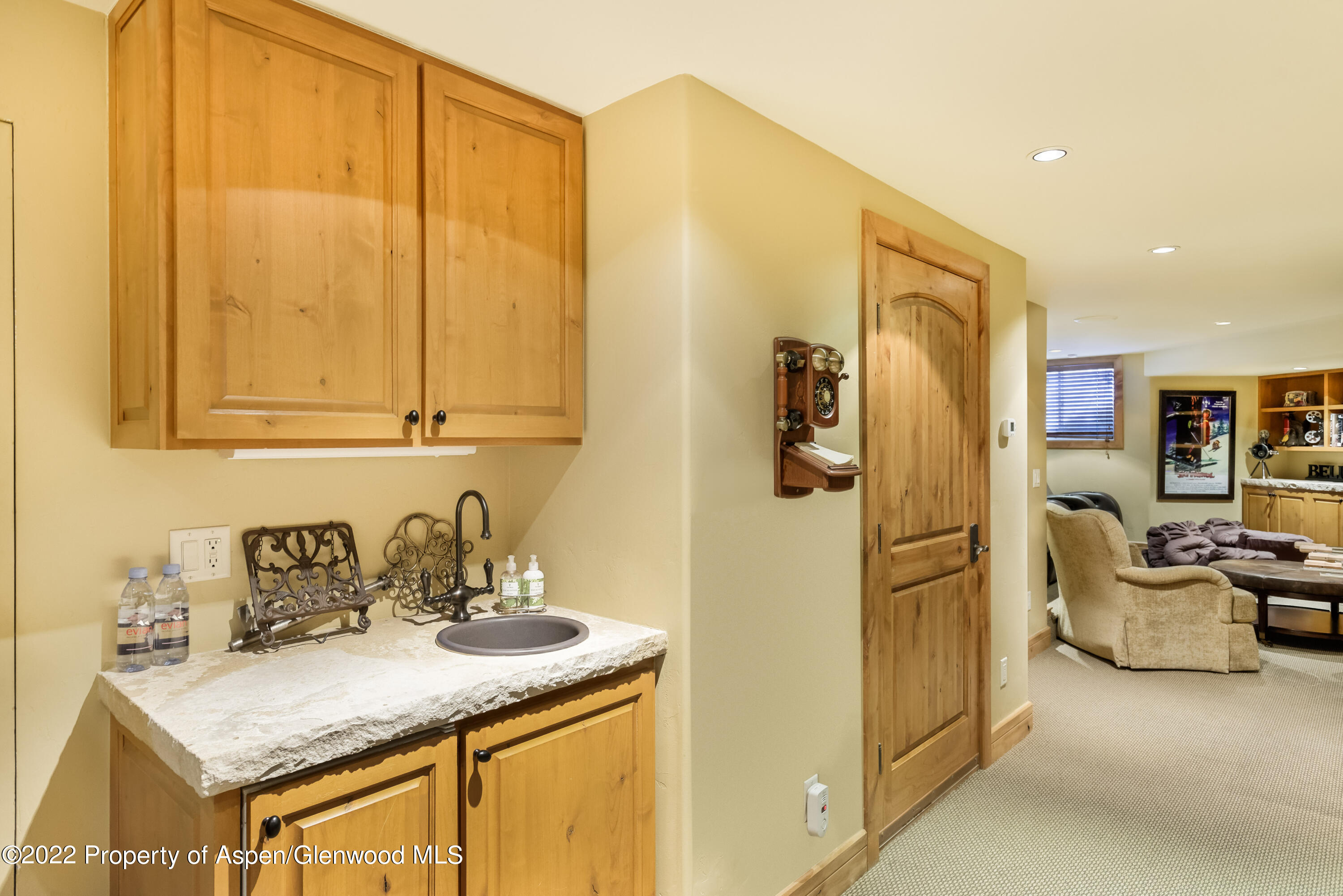 1400 Wood Road Snowmass Village, CO 81615 - Photo 23 of 36 a kitchen with stainless steel appliances granite countertop a sink and cabinets