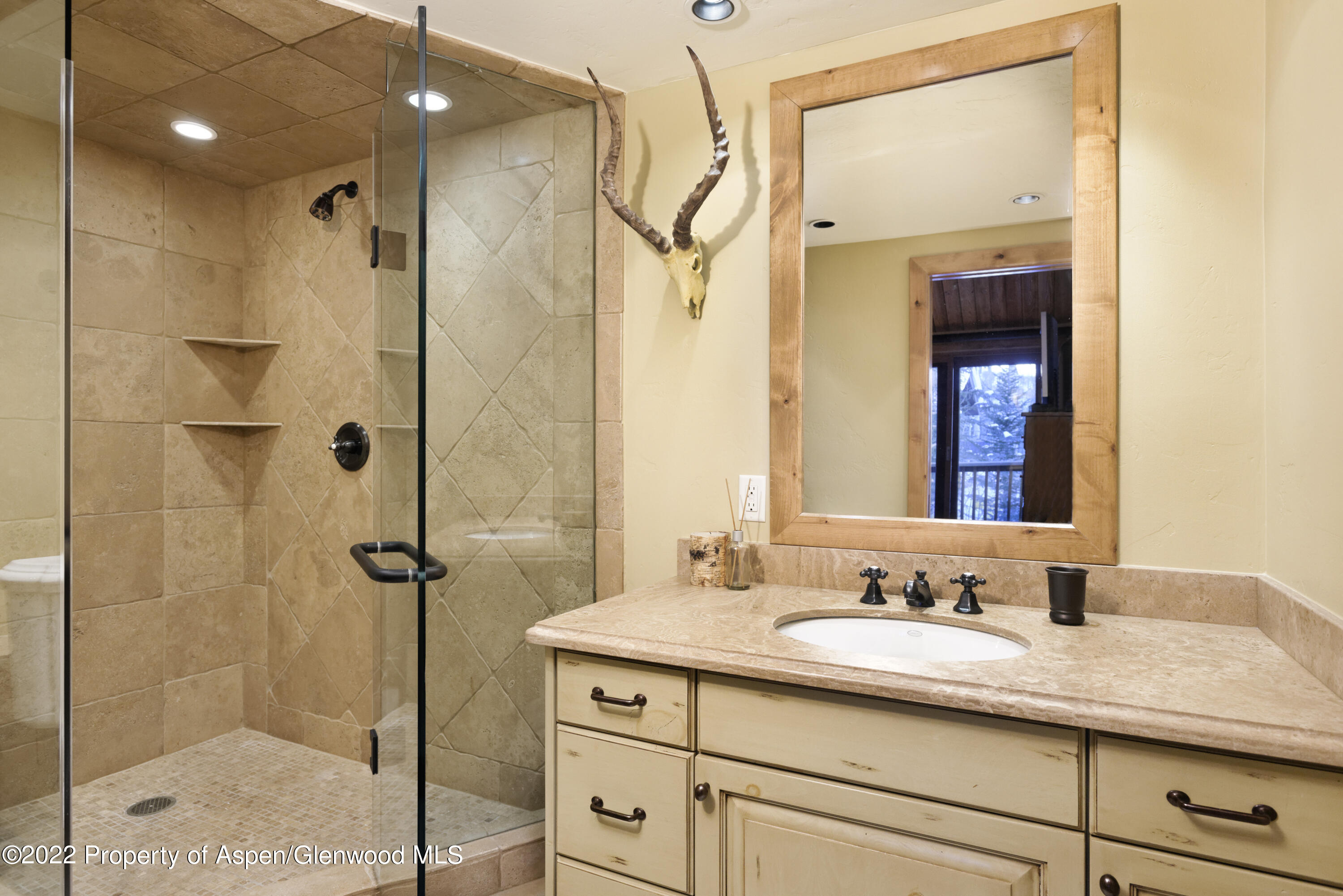 1400 Wood Road Snowmass Village, CO 81615 - Photo 24 of 36 a bathroom with a granite countertop sink mirror and shower