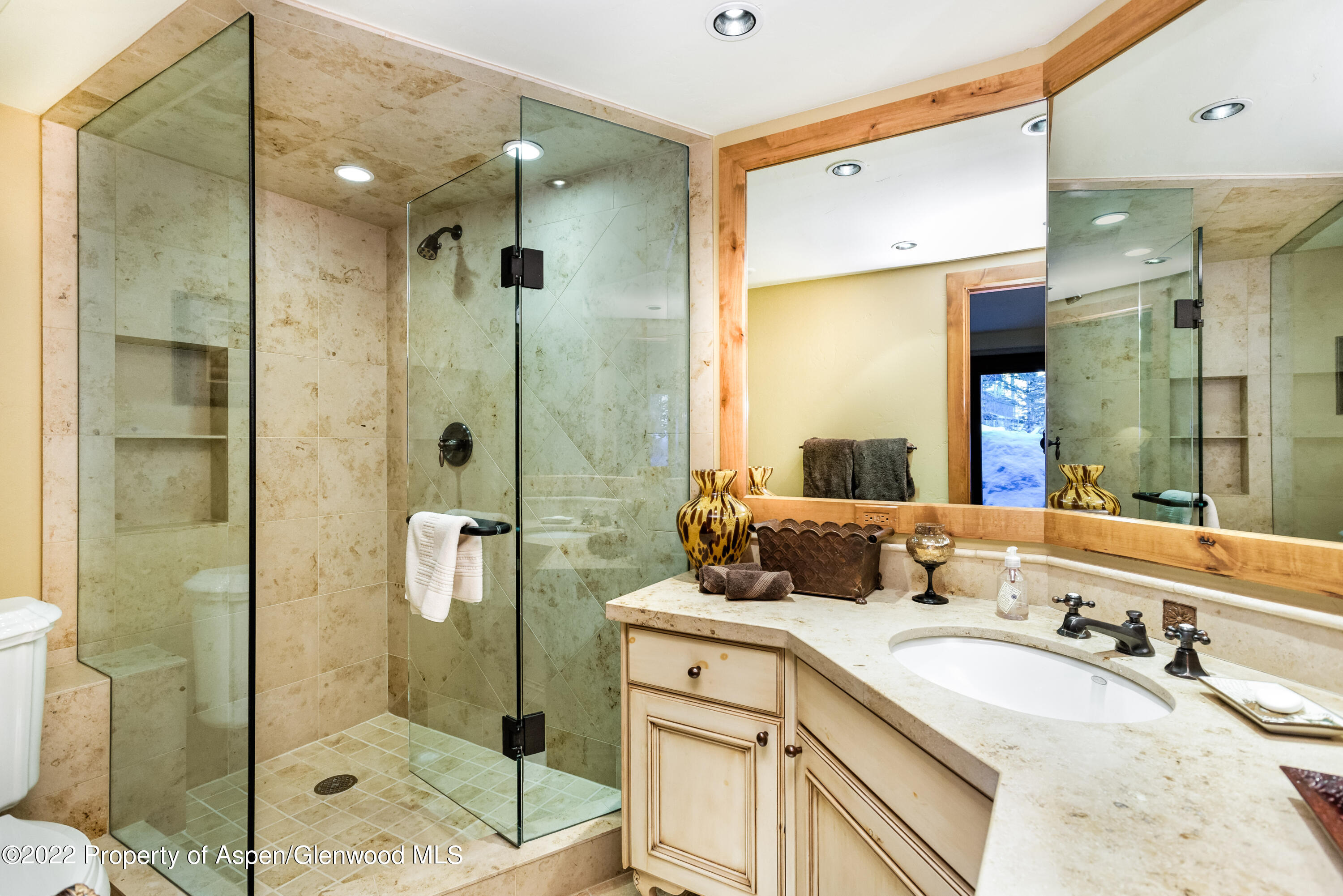 1400 Wood Road Snowmass Village, CO 81615 - Photo 30 of 36 a bathroom with a granite countertop sink mirror and shower