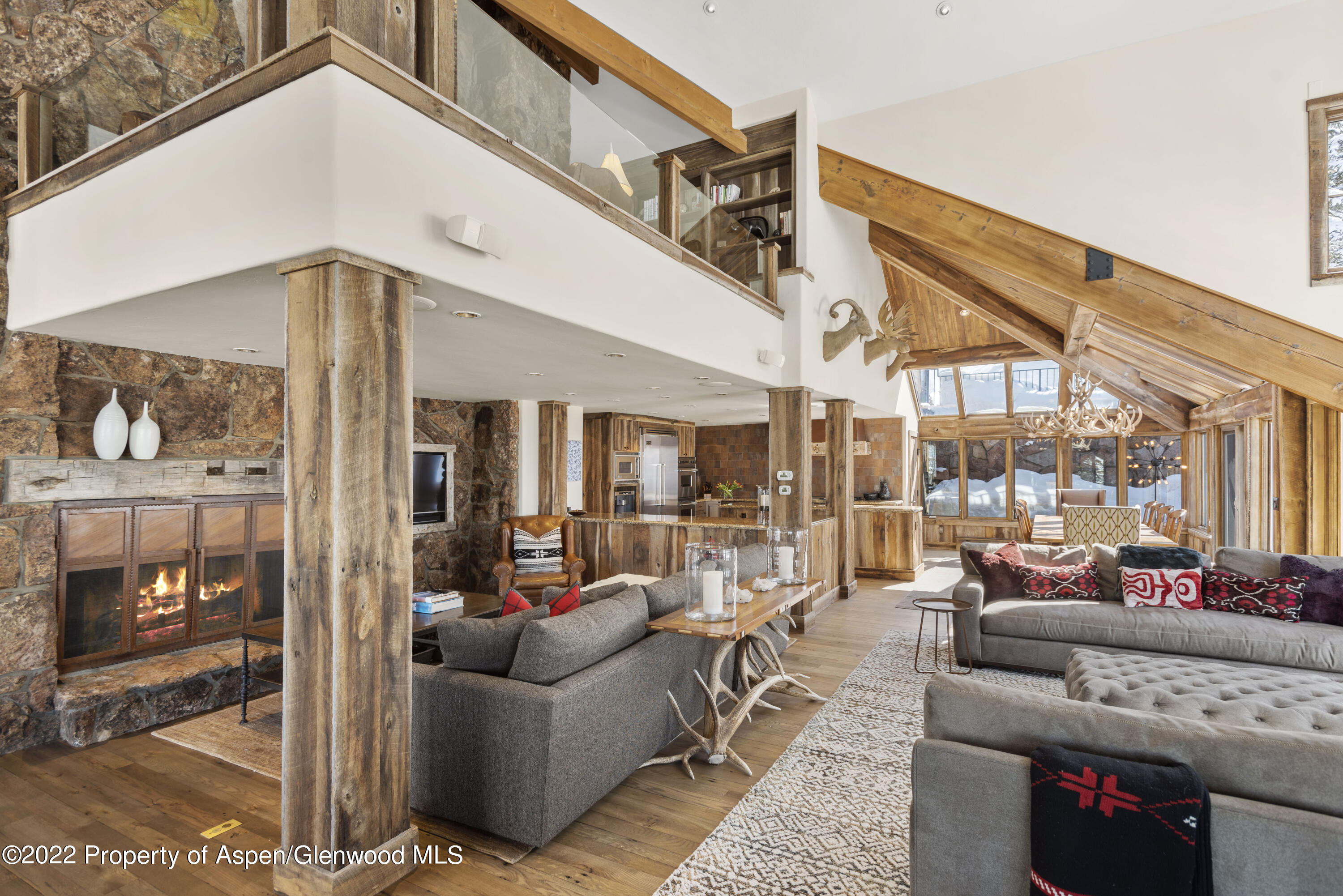 1400 Wood Road Snowmass Village, CO 81615 - Photo 3 of 36 a living room with furniture a lamp and a floor to ceiling window