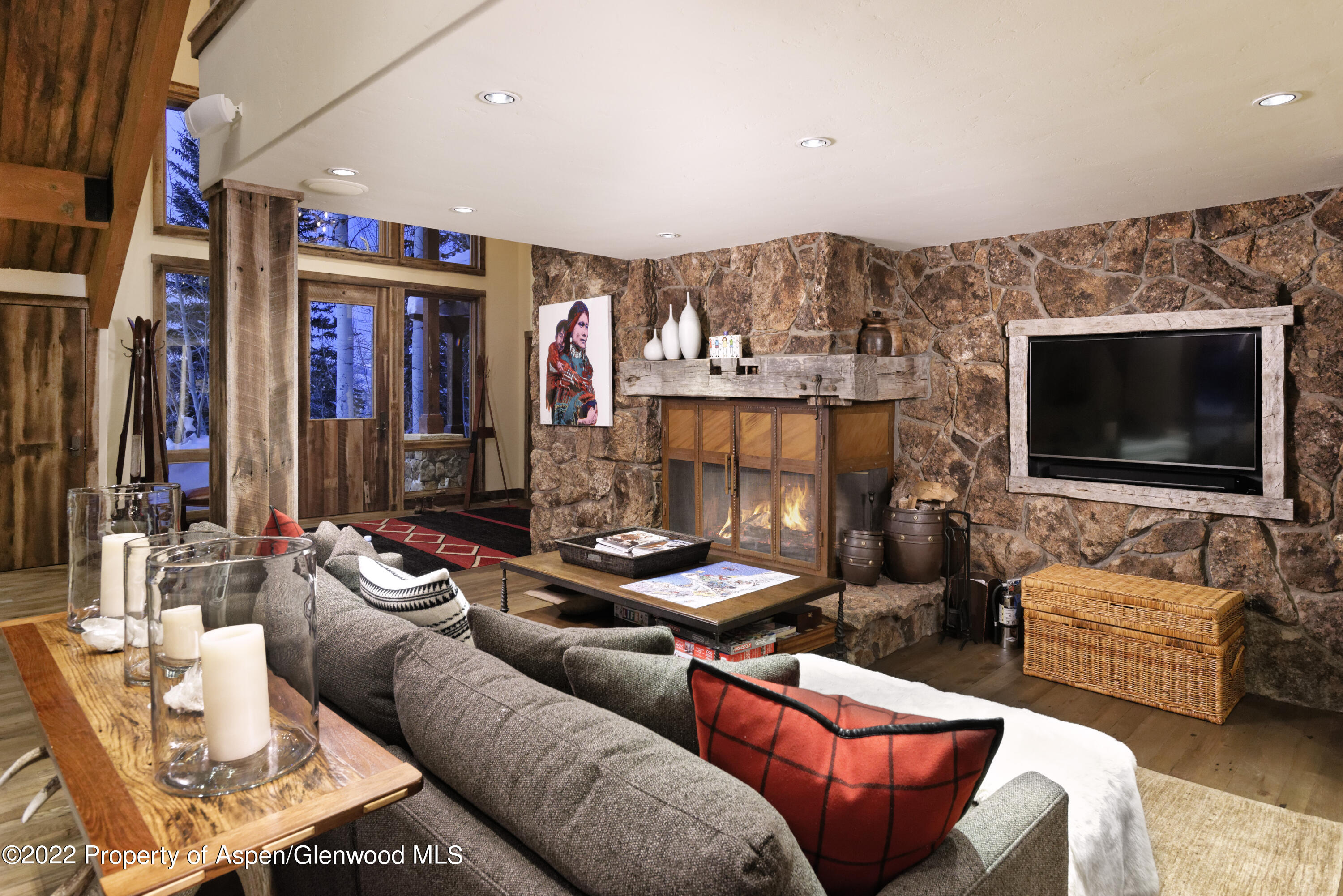 1400 Wood Road Snowmass Village, CO 81615 - Photo 4 of 36 a living room with furniture and a flat screen tv