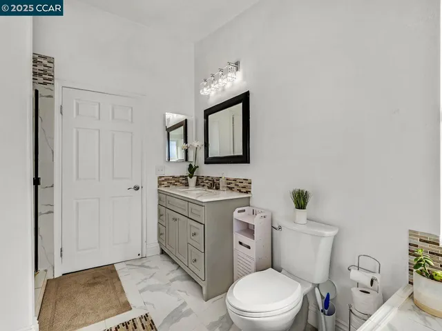 a view of a roof deck with two couches and wooden floor