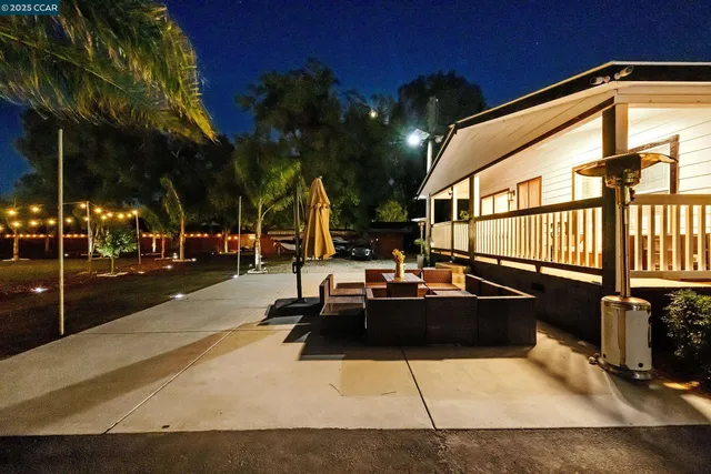 a view of living room with furniture and a kitchen view