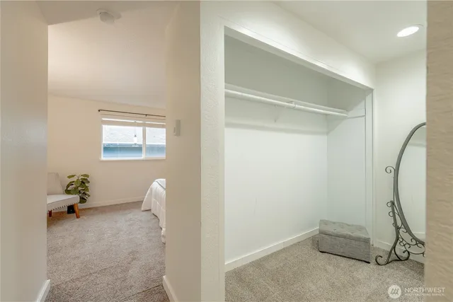 a room with a mirror and a fan