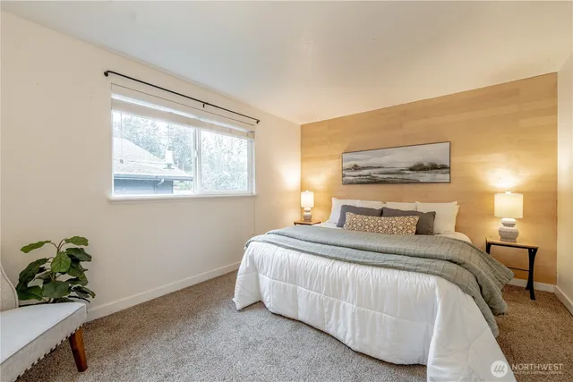 a bedroom with a bed plant and a window