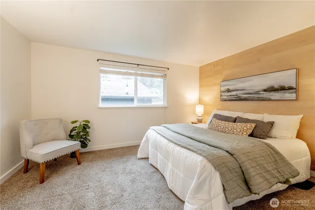 a bedroom with a bed and a couch