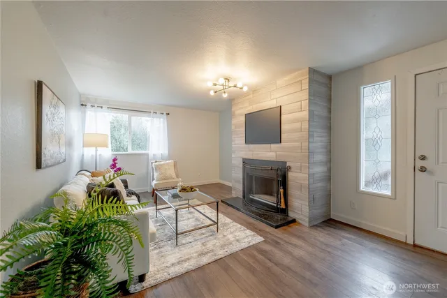 a living room with furniture and a fireplace